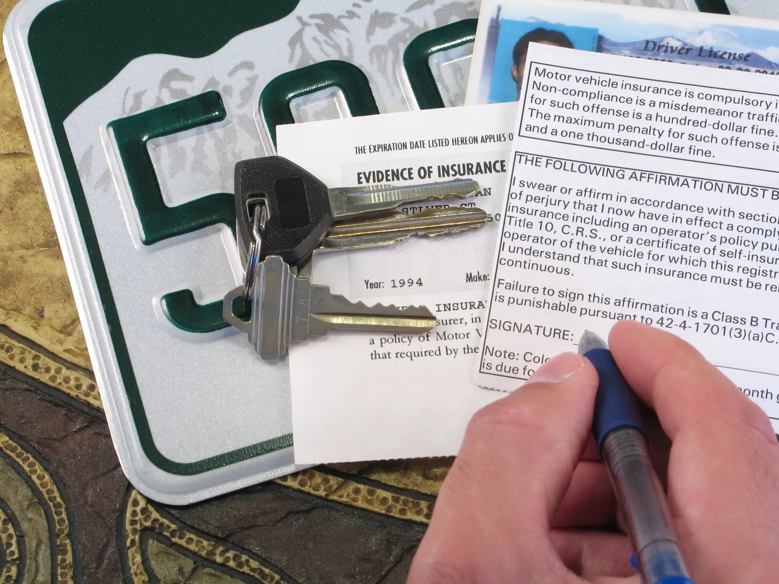 Vehicle registration and insurance paperwork in Alberta
