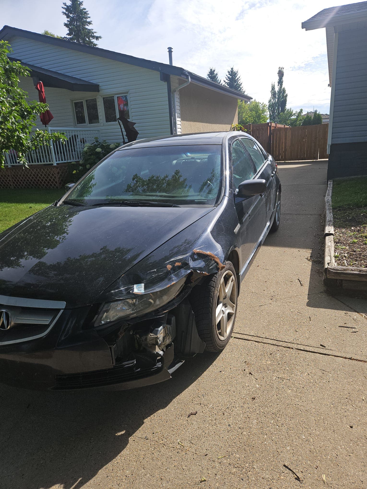 Damaged vehicle in Edmonton driveway